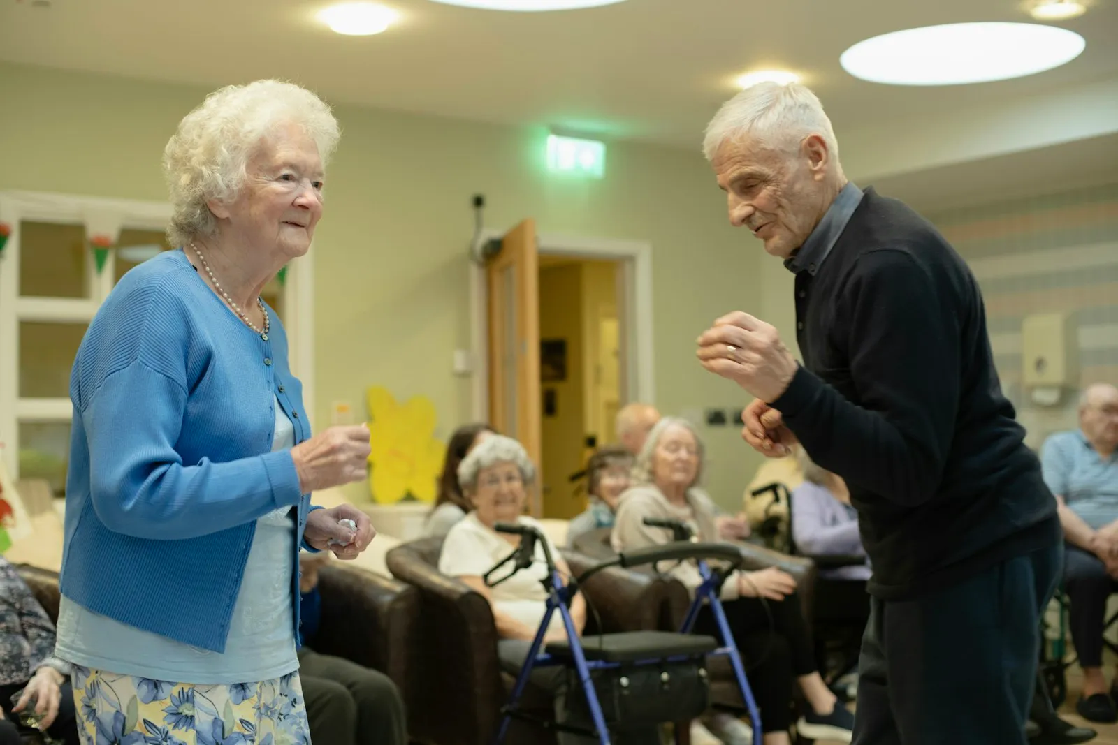 An older couple dancing while friends smile and watch