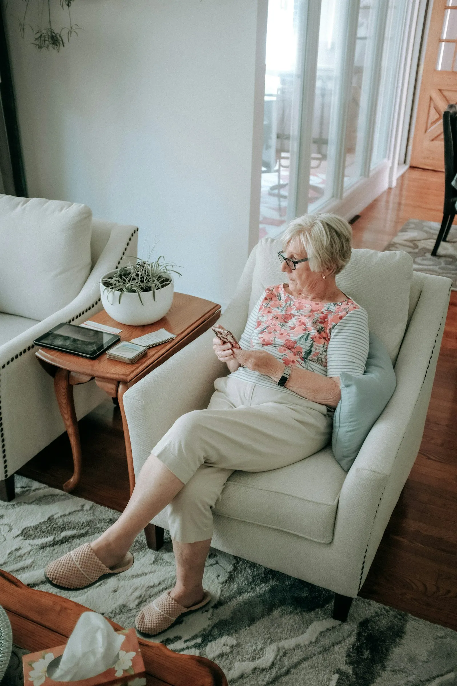 An older woman relaxing in a comfortable armchair